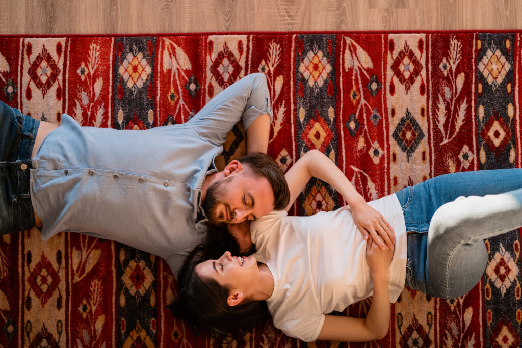 young couple laying on the rug